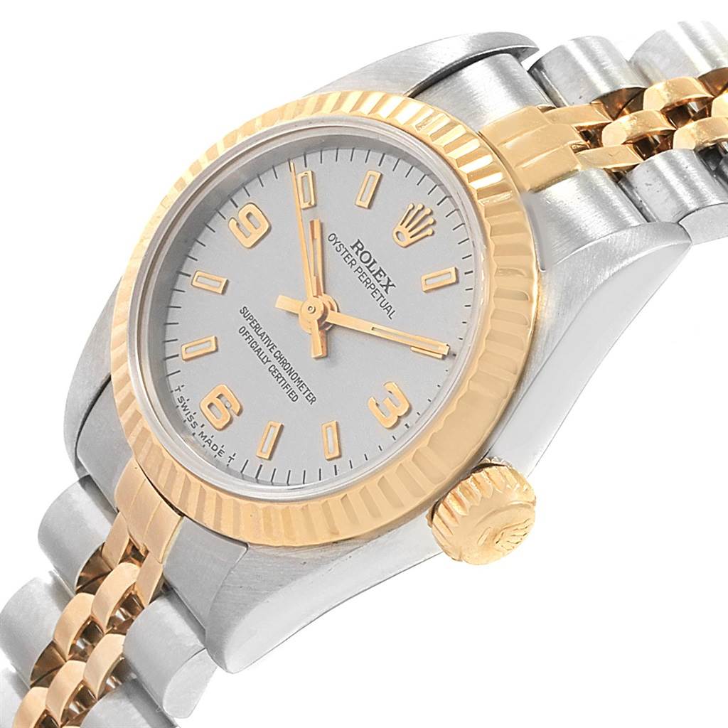 This Rolex Oyster Perpetual 67193 Women's Steel and Gold (two tone) Grey Dial 67193 Women's Steel and Gold (two tone) Grey Dial watch is shown from a side angle, highlighting the dial, bezel, crown, and bracelet.