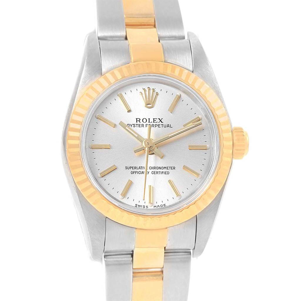 This image shows the front view of a Rolex Oyster Perpetual 76193 Women's Steel and Gold (two tone) Silver Dial 76193 Women's Steel and Gold (two tone) Silver Dial watch featuring a gold and silver bracelet and a fluted bezel.