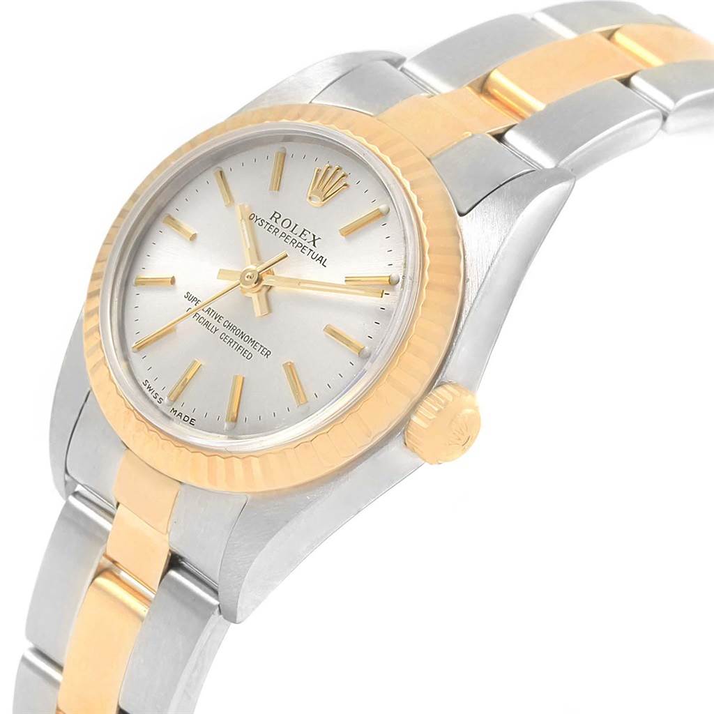 This image shows a Rolex Oyster Perpetual 76193 Women's Steel and Gold (two tone) Silver Dial 76193 Women's Steel and Gold (two tone) Silver Dial watch from an angled side view, highlighting the dial, crown, and two-tone bracelet.