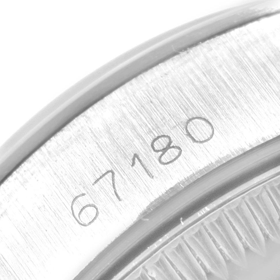 This close-up image shows the serial number engraved on the side of a Rolex Oyster Perpetual 67180 Women's Stainless Steel White Dial 67180 Women's Stainless Steel White Dial watch case.