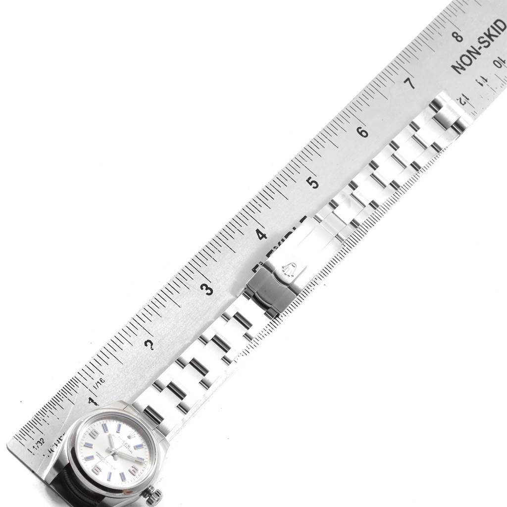The image shows the front of the Rolex Oyster Perpetual 176200 Women's Stainless Steel Silver Dial 176200 Women's Stainless Steel Silver Dial watch, highlighting its face and metal bracelet, alongside a ruler for measurement.