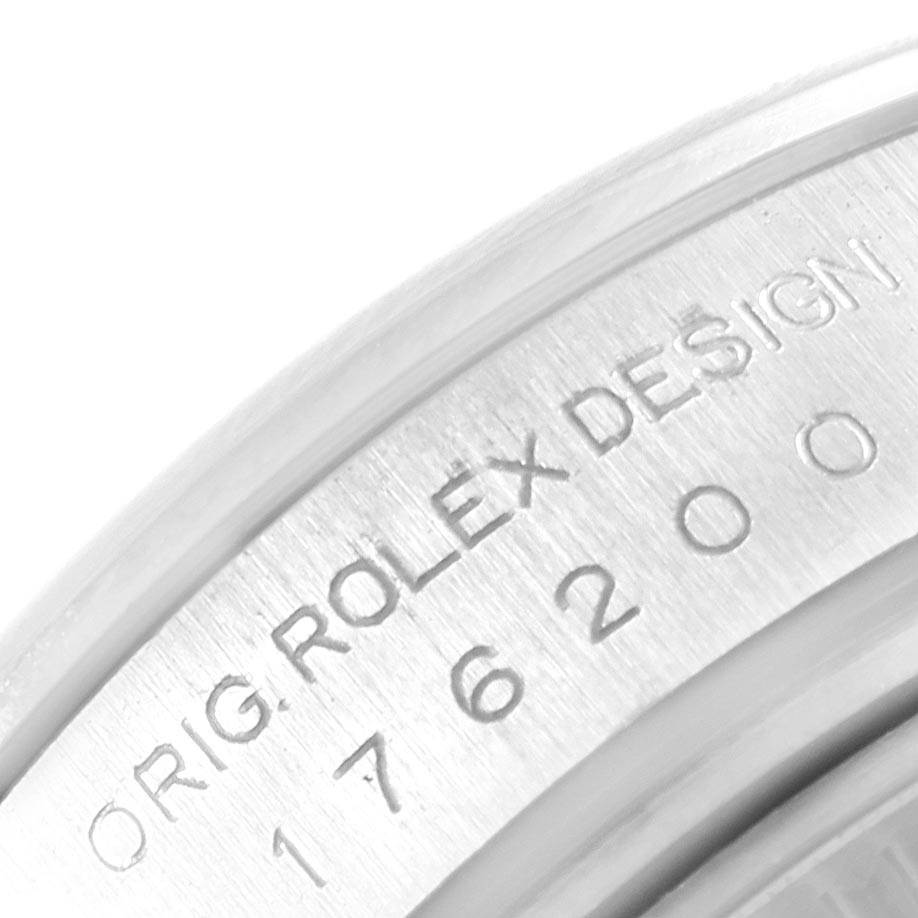 This image shows a close-up of the engraved bezel of a Rolex Oyster Perpetual 176200 Women's Stainless Steel Silver Dial 176200 Women's Stainless Steel Silver Dial watch.