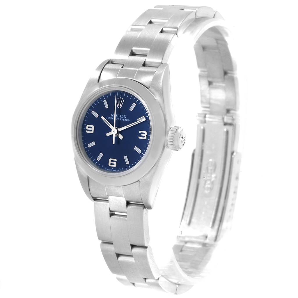 The Rolex Oyster Perpetual 67180 Women's Stainless Steel Blue Dial 67180 Women's Stainless Steel Blue Dial watch is shown at a three-quarter angle, highlighting its blue dial, crown, and stainless steel bracelet.