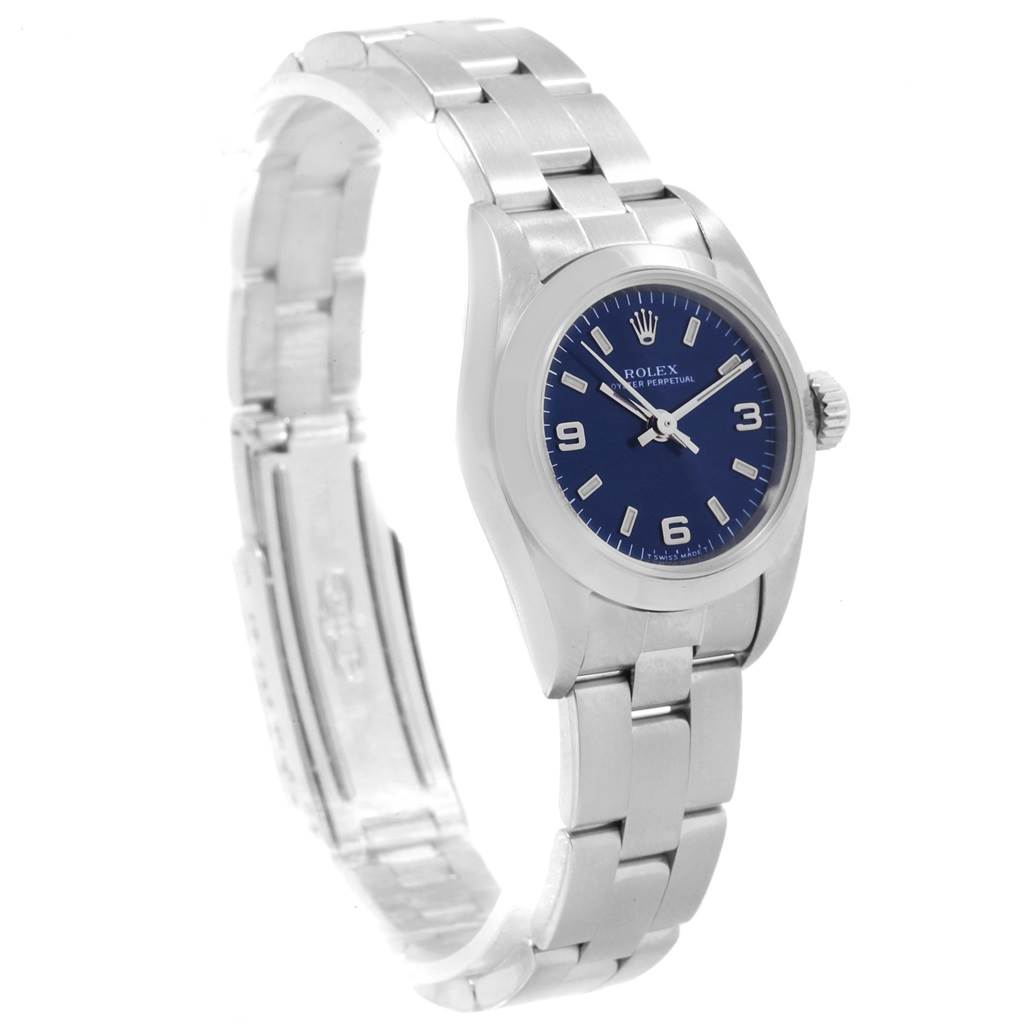 The image shows a side view of a Rolex Oyster Perpetual 67180 Women's Stainless Steel Blue Dial 67180 Women's Stainless Steel Blue Dial watch with its blue dial and stainless steel bracelet.