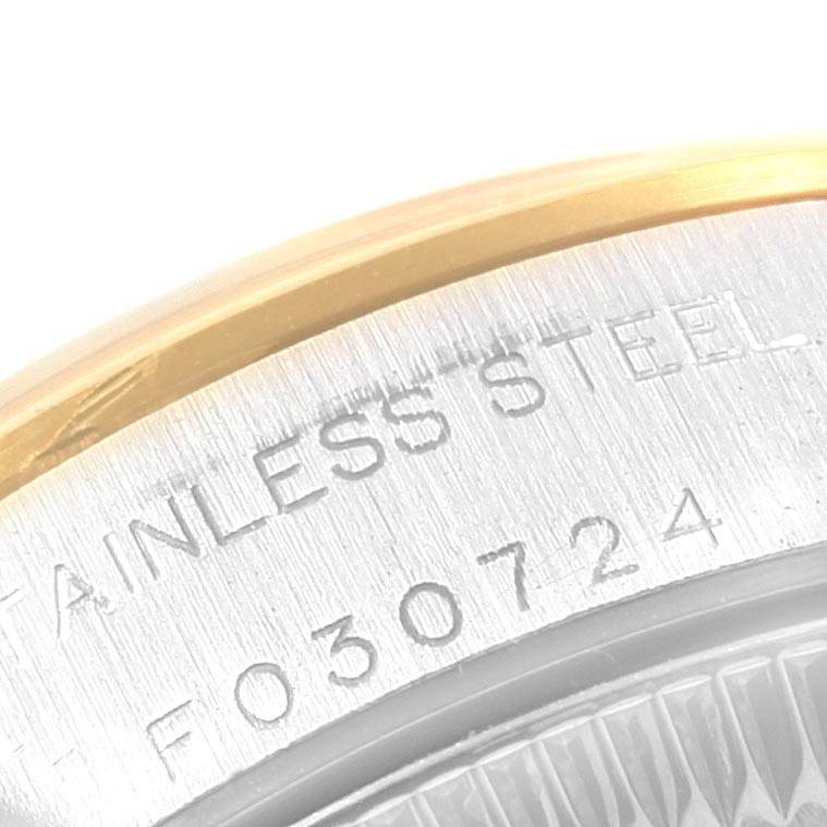 This image shows a close-up of the side casing and part of the bezel of a Rolex Oyster Perpetual 76183 Women's Steel and Gold (two tone) Silver Dial 76183 Women's Steel and Gold (two tone) Silver Dial watch, revealing its stainless steel material and serial number.