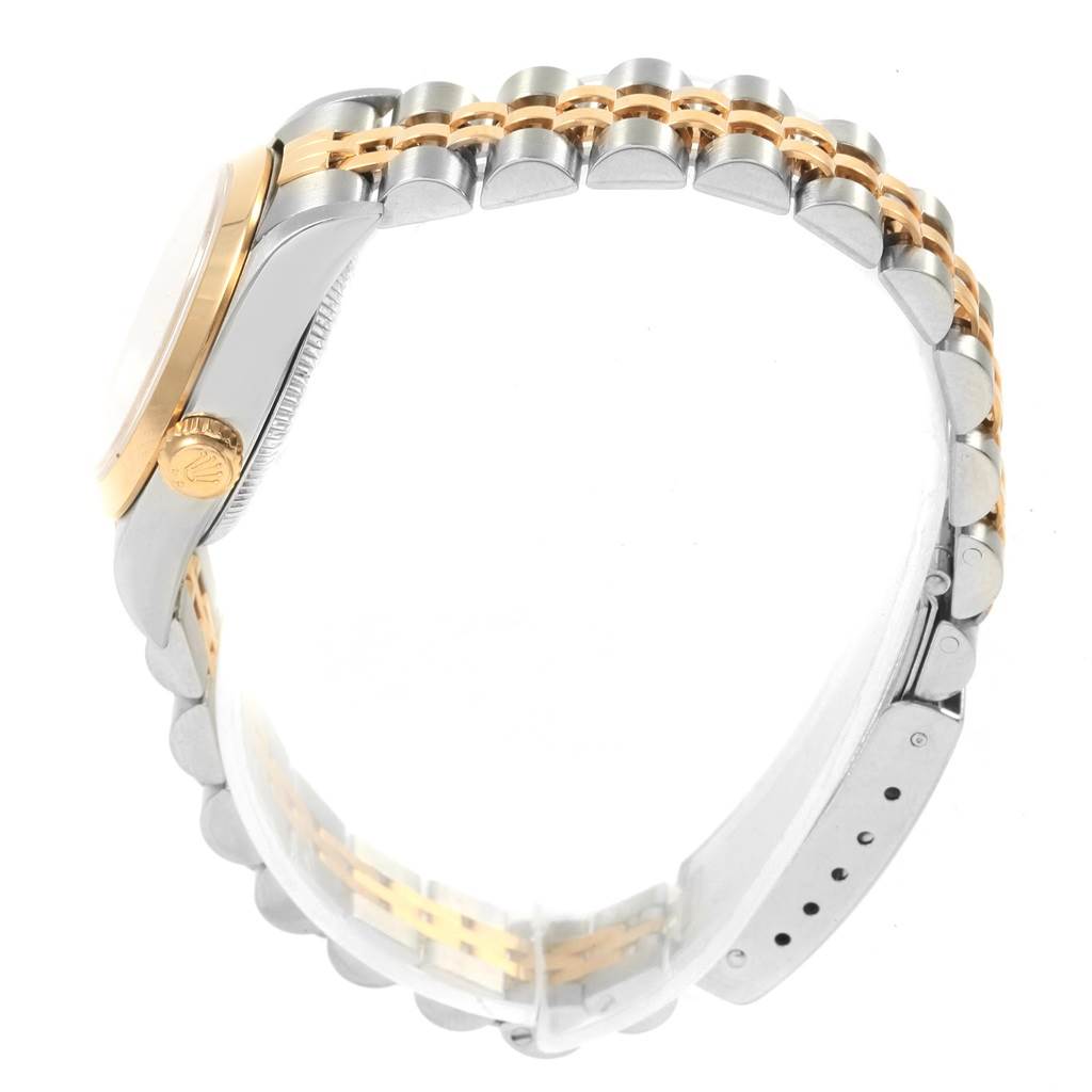 The image shows a side view of a Rolex Oyster Perpetual 76183 Women's Steel and Gold (two tone) Silver Dial 76183 Women's Steel and Gold (two tone) Silver Dial watch, highlighting its two-tone metal band and crown.