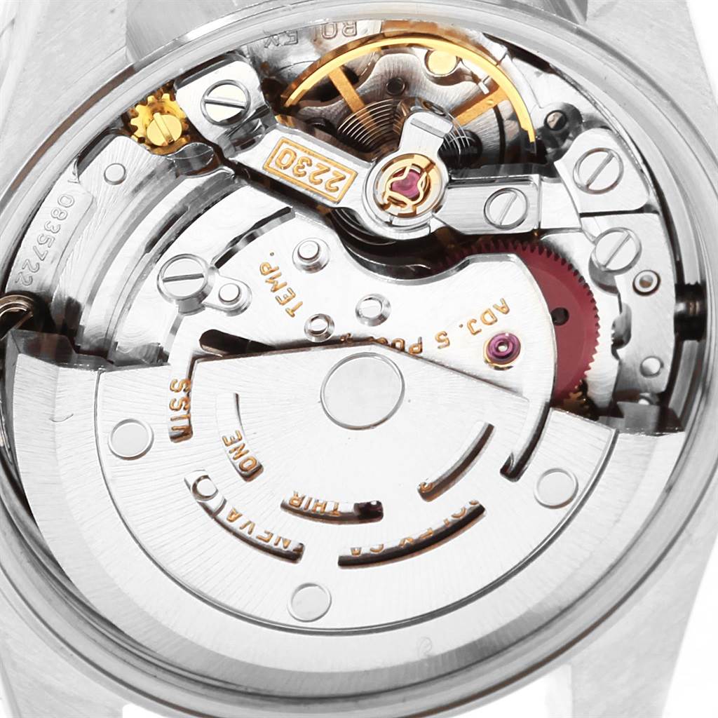 This image shows the inner mechanism and movement of a Rolex Oyster Perpetual 76183 Women's Steel and Gold (two tone) Silver Dial 76183 Women's Steel and Gold (two tone) Silver Dial watch from a close-up angle.