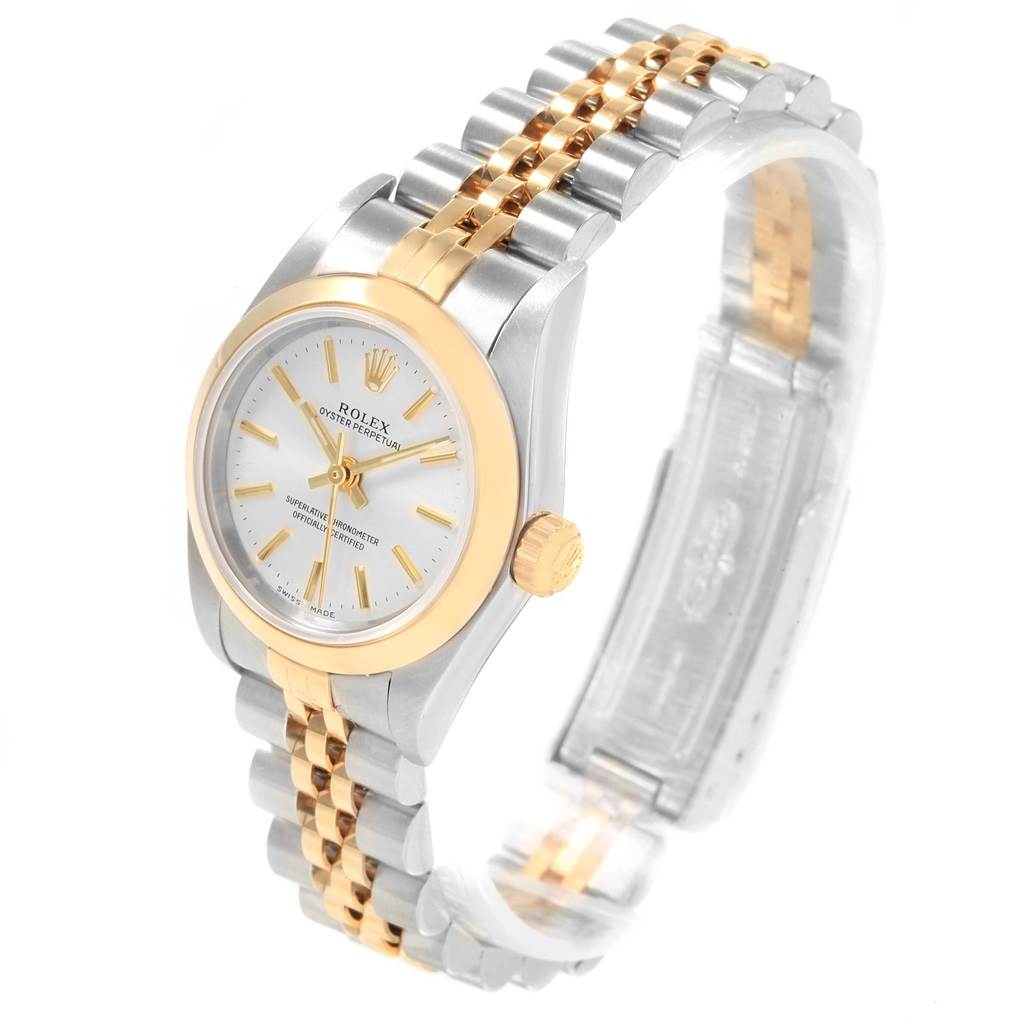 The Rolex Oyster Perpetual 76183 Women's Steel and Gold (two tone) Silver Dial 76183 Women's Steel and Gold (two tone) Silver Dial watch is shown at a slight angle highlighting its dial, bezel, crown, and two-tone bracelet.