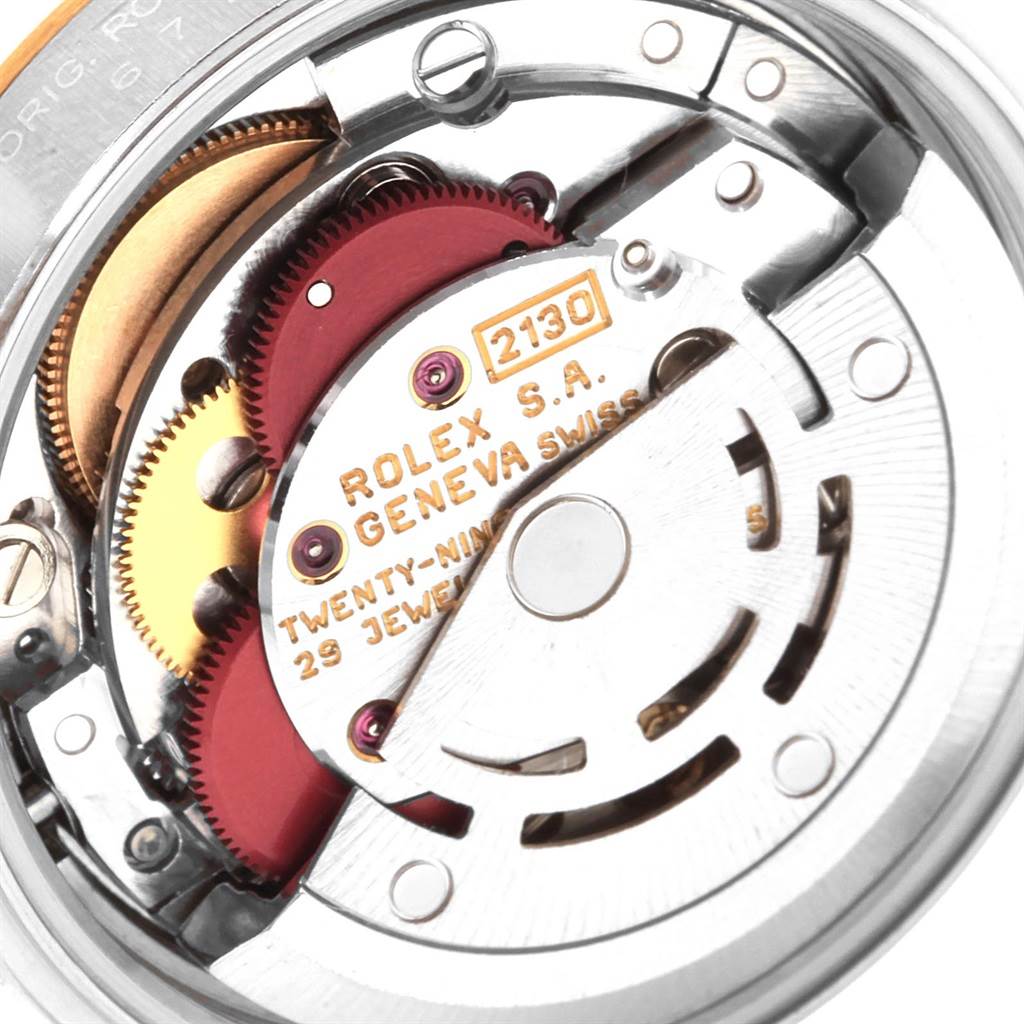 This close-up image shows the internal movement and components of a Rolex Oyster Perpetual 67193 Women's Steel and Gold (two tone) Silver Dial 67193 Women's Steel and Gold (two tone) Silver Dial watch, with the model number 2130 visible.