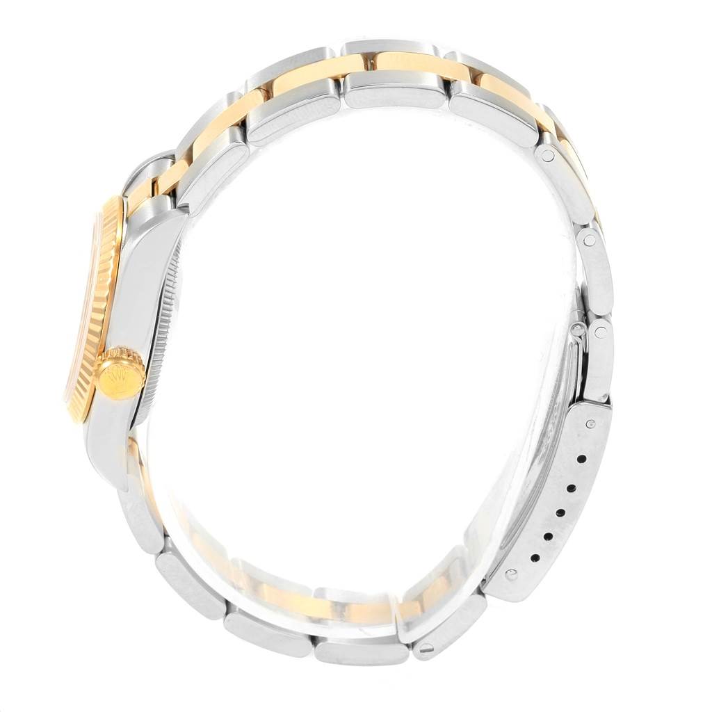 The image shows a side view of the Rolex Oyster Perpetual 67193 Women's Steel and Gold (two tone) Silver Dial 67193 Women's Steel and Gold (two tone) Silver Dial watch, highlighting the gold and silver bracelet and crown.