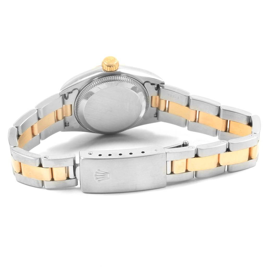 The image shows the back view of a Rolex Oyster Perpetual 67193 Women's Steel and Gold (two tone) Silver Dial 67193 Women's Steel and Gold (two tone) Silver Dial watch with its metal and gold-tone bracelet and closed clasp.