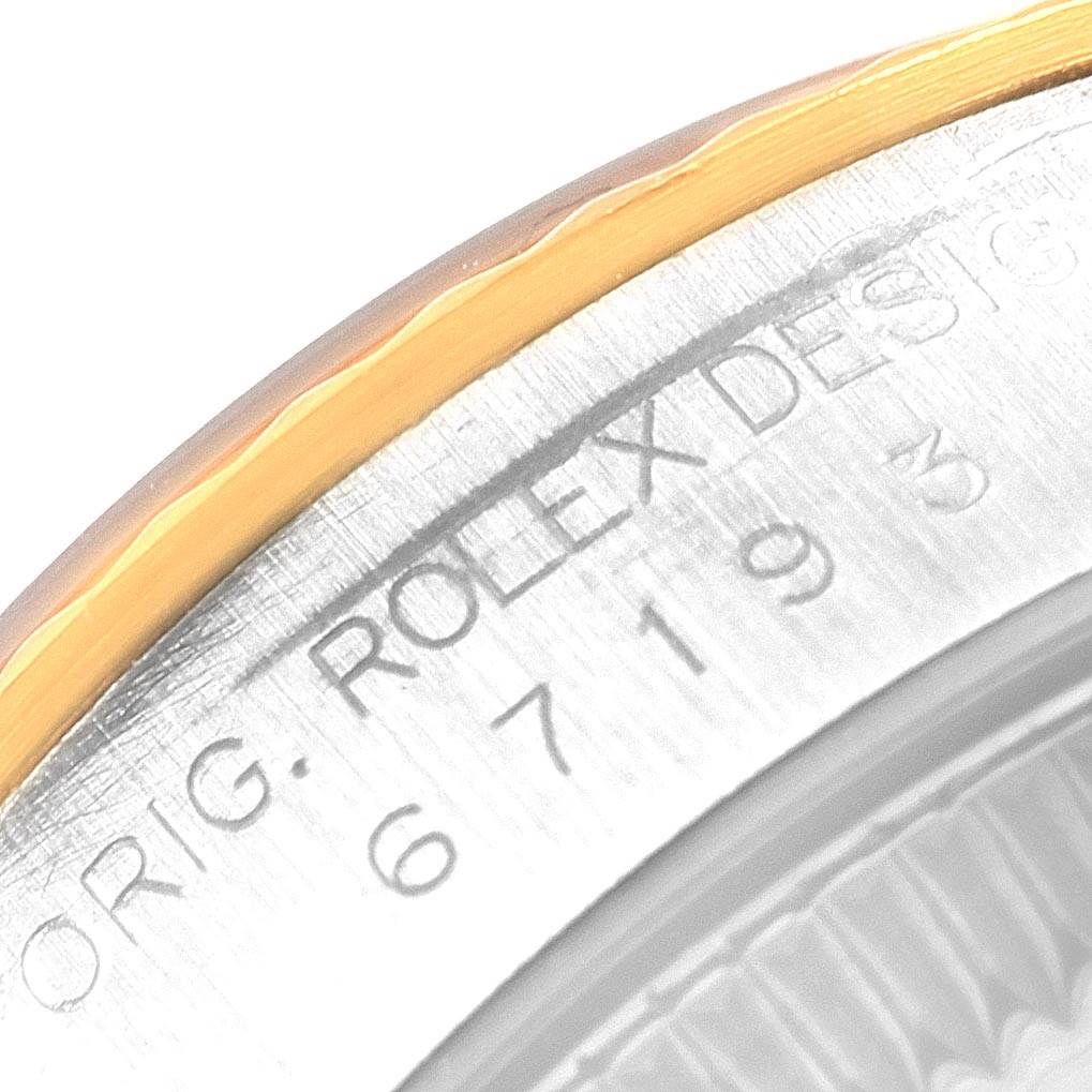 This close-up image shows part of the casing on a Rolex Oyster Perpetual 67193 Women's Steel and Gold (two tone) Silver Dial 67193 Women's Steel and Gold (two tone) Silver Dial watch, highlighting the engraved model number.