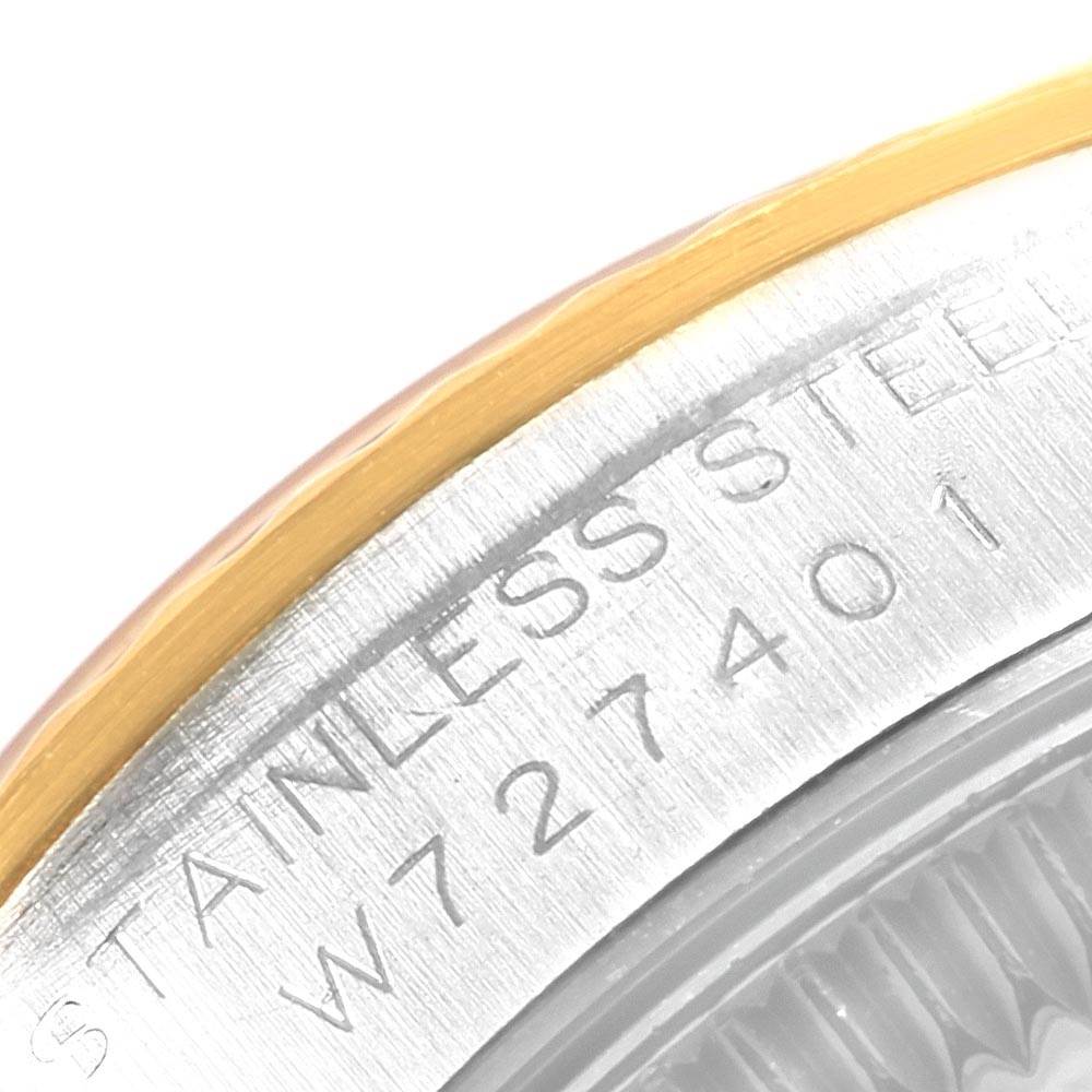 This image shows a close-up of the case back edge and part of the bezel of a Rolex Oyster Perpetual 67193 Women's Steel and Gold (two tone) Silver Dial 67193 Women's Steel and Gold (two tone) Silver Dial watch, highlighting the engraved serial number.