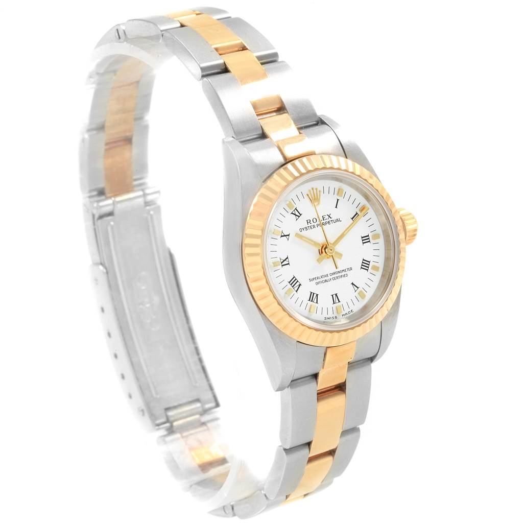 The Rolex Oyster Perpetual 76193 Women's Steel and Gold (two tone) White Dial 76193 Women's Steel and Gold (two tone) White Dial watch is shown from a front-left angle, displaying the face, bezel, and part of the bracelet.