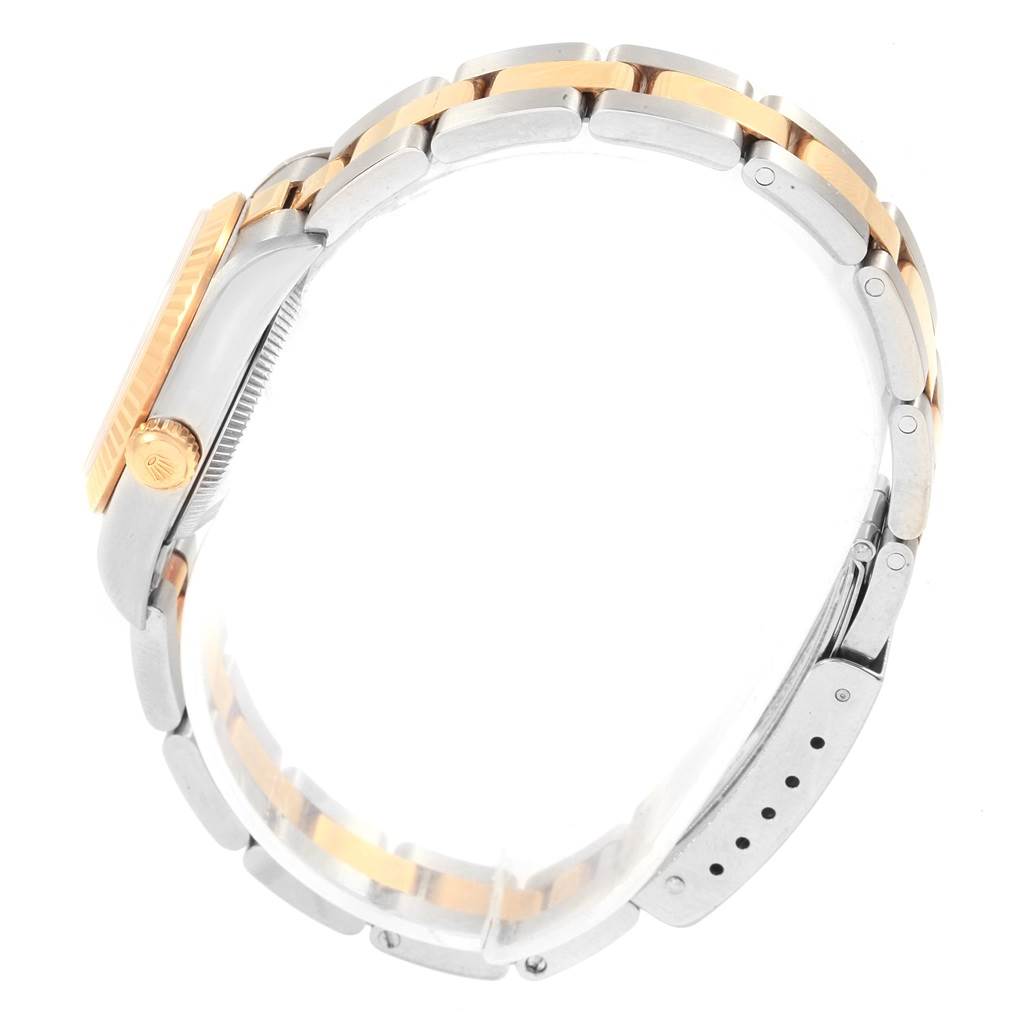 The image shows a side view of the Rolex Oyster Perpetual 76193 Women's Steel and Gold (two tone) White Dial 76193 Women's Steel and Gold (two tone) White Dial watch, focusing on the two-tone bracelet and the crown.