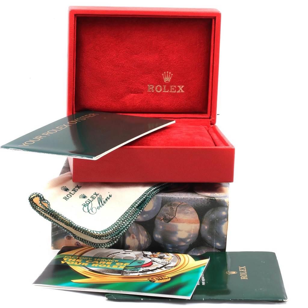 The image shows packaging and accessories for a Rolex Oyster Perpetual 76193 Women's Steel and Gold (two tone) White Dial 76193 Women's Steel and Gold (two tone) White Dial, including a red watch box and booklets.