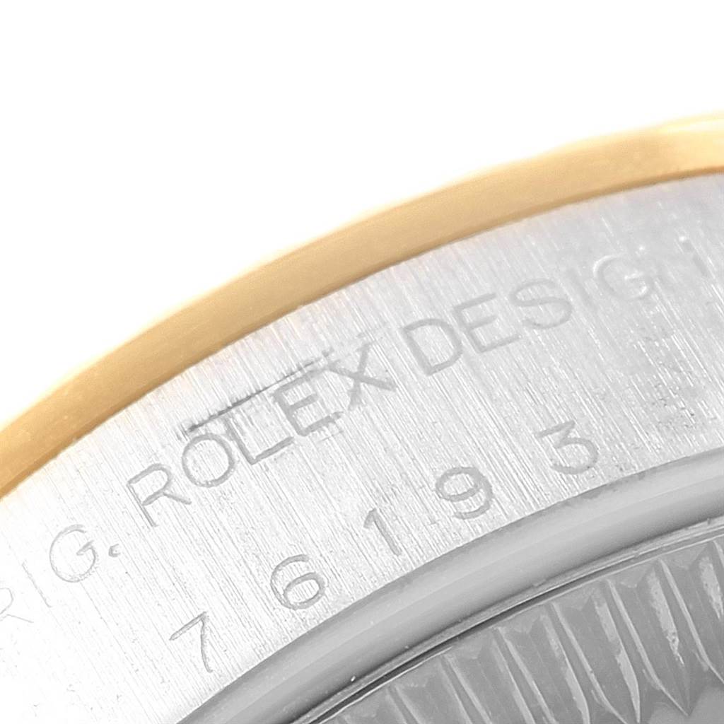 This close-up image shows the engraved lettering on the side of a Rolex Oyster Perpetual 76193 Women's Steel and Gold (two tone) White Dial 76193 Women's Steel and Gold (two tone) White Dial watch case.