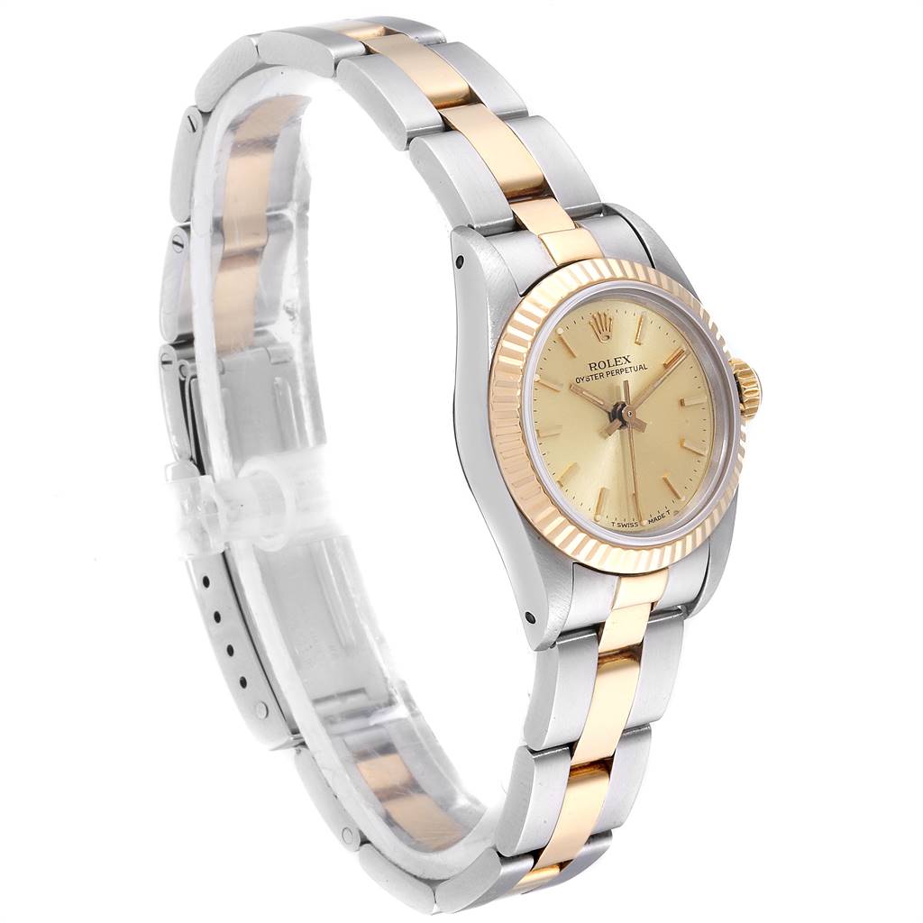 The image shows a side angle of a Rolex Oyster Perpetual 67193 Women
s Steel and Gold (two tone) Champagne Dial 67193 Women
s Steel and Gold (two tone) Champagne Dial watch, highlighting the bezel, dial, crown, and two-tone metal bracelet.