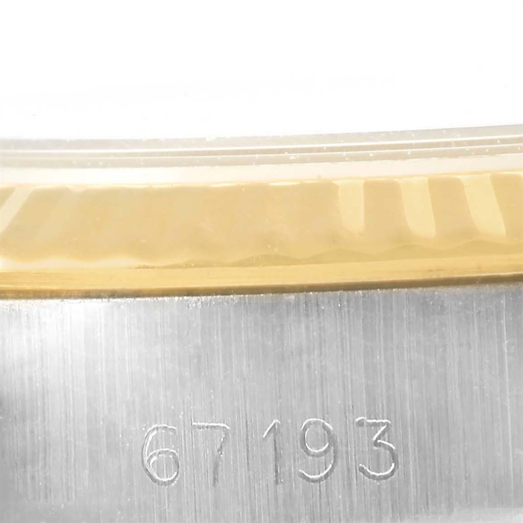 The image shows a close-up view of the bezel and the reference number engraved on the case of a Rolex Oyster Perpetual 67193 Women
s Steel and Gold (two tone) Champagne Dial 67193 Women
s Steel and Gold (two tone) Champagne Dial watch model.
