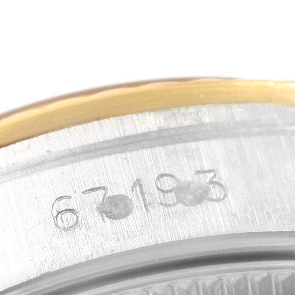 This close-up image of a Rolex Oyster Perpetual 67193 Women's Steel and Gold (two tone) Champagne Dial 67193 Women's Steel and Gold (two tone) Champagne Dial watch shows part of the case with the engraved model number.