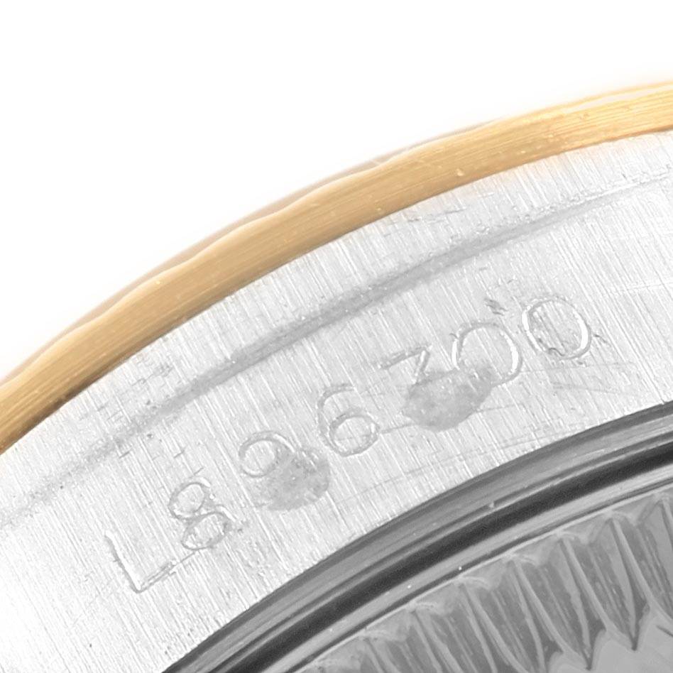 The image shows a close-up angle of the model and serial number engraving on the case of a Rolex Oyster Perpetual 67193 Women's Steel and Gold (two tone) Champagne Dial 67193 Women's Steel and Gold (two tone) Champagne Dial watch.