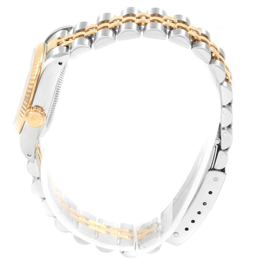 The image shows a side view of the Rolex Oyster Perpetual 67193 Women's Steel and Gold (two tone) Champagne Dial 67193 Women's Steel and Gold (two tone) Champagne Dial watch, highlighting the two-tone bracelet and crown.