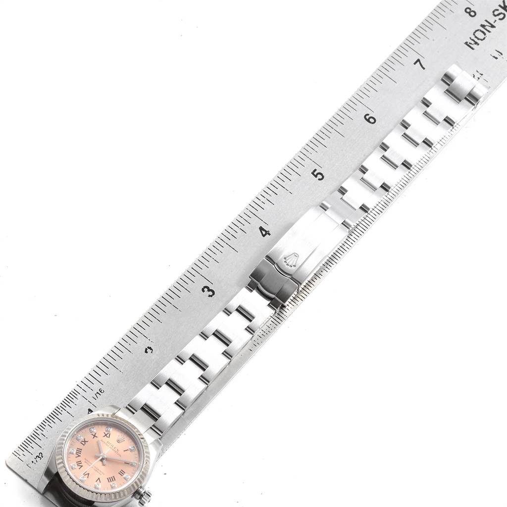 This image shows a Rolex Oyster Perpetual 176234 Women's Stainless Steel Pink Dial 176234 Women's Stainless Steel Pink Dial watch laid next to a ruler for size reference, with a focus on the bracelet and clasp.