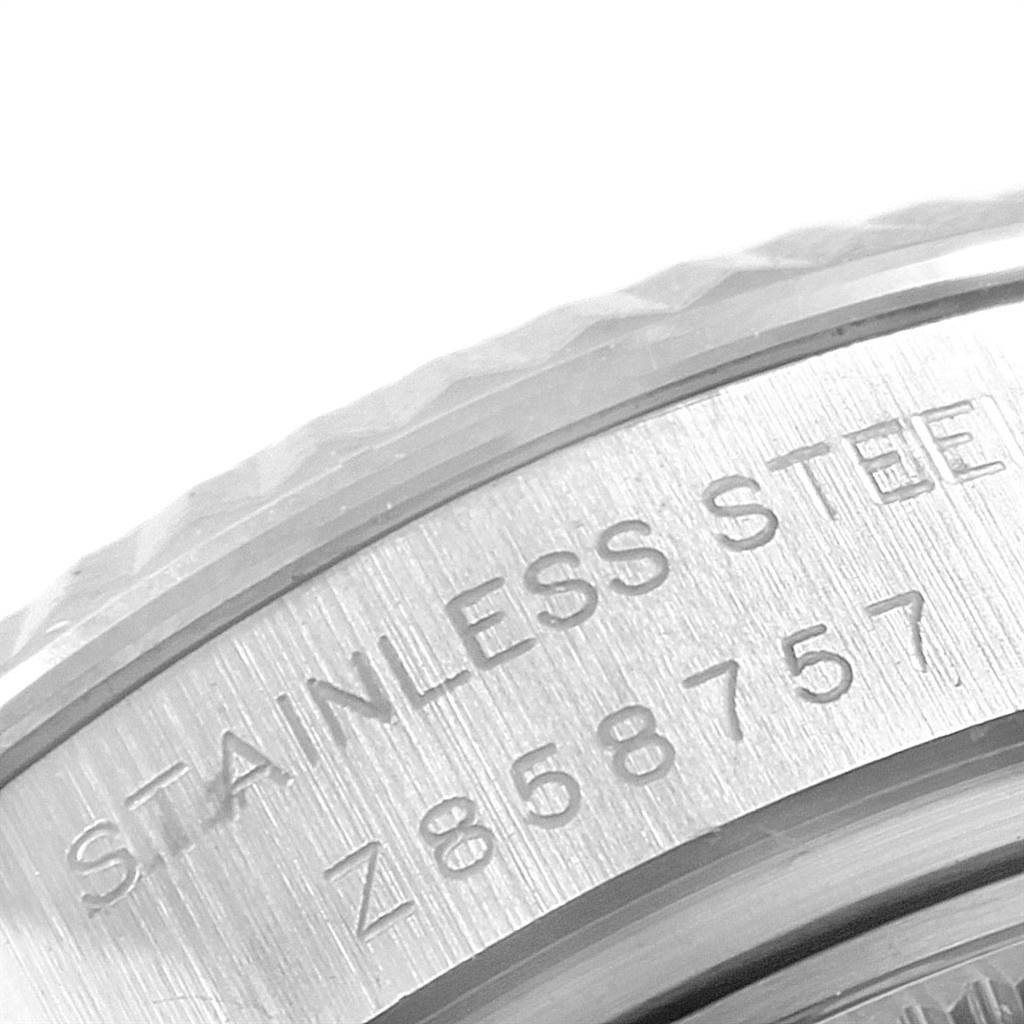 This image shows a close-up of the side of the bezel of a Rolex Oyster Perpetual 176234 Women's Stainless Steel Pink Dial 176234 Women's Stainless Steel Pink Dial watch, highlighting the "STAINLESS STEEL" engraving.