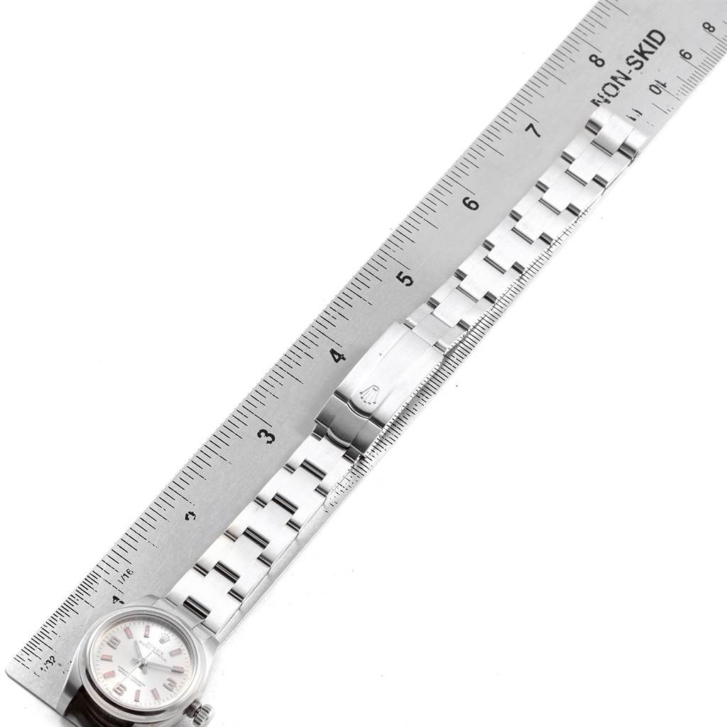 The image shows the Rolex Oyster Perpetual 176200 Women's Stainless Steel Silver Dial 176200 Women's Stainless Steel Silver Dial watch laid beside a non-skid ruler, displaying its bracelet and clasp.