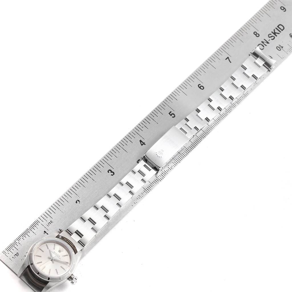 The image shows a flatlay of a Rolex Oyster Perpetual 76030 Women
s Stainless Steel Silver Dial 76030 Women
s Stainless Steel Silver Dial watch with its bracelet measured against a ruler.