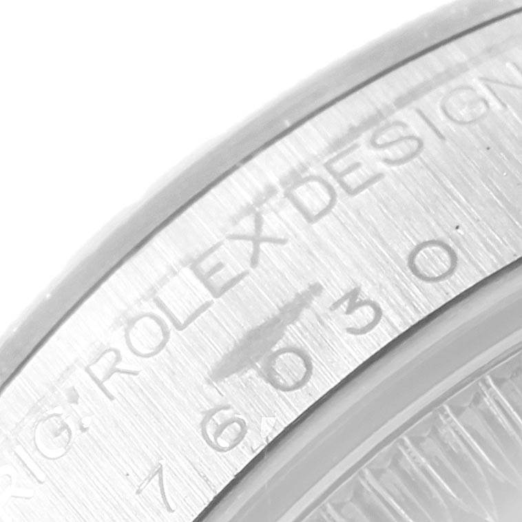 This close-up image shows part of the engraved bezel of the Rolex Oyster Perpetual 76030 Women
s Stainless Steel Silver Dial 76030 Women
s Stainless Steel Silver Dial watch.