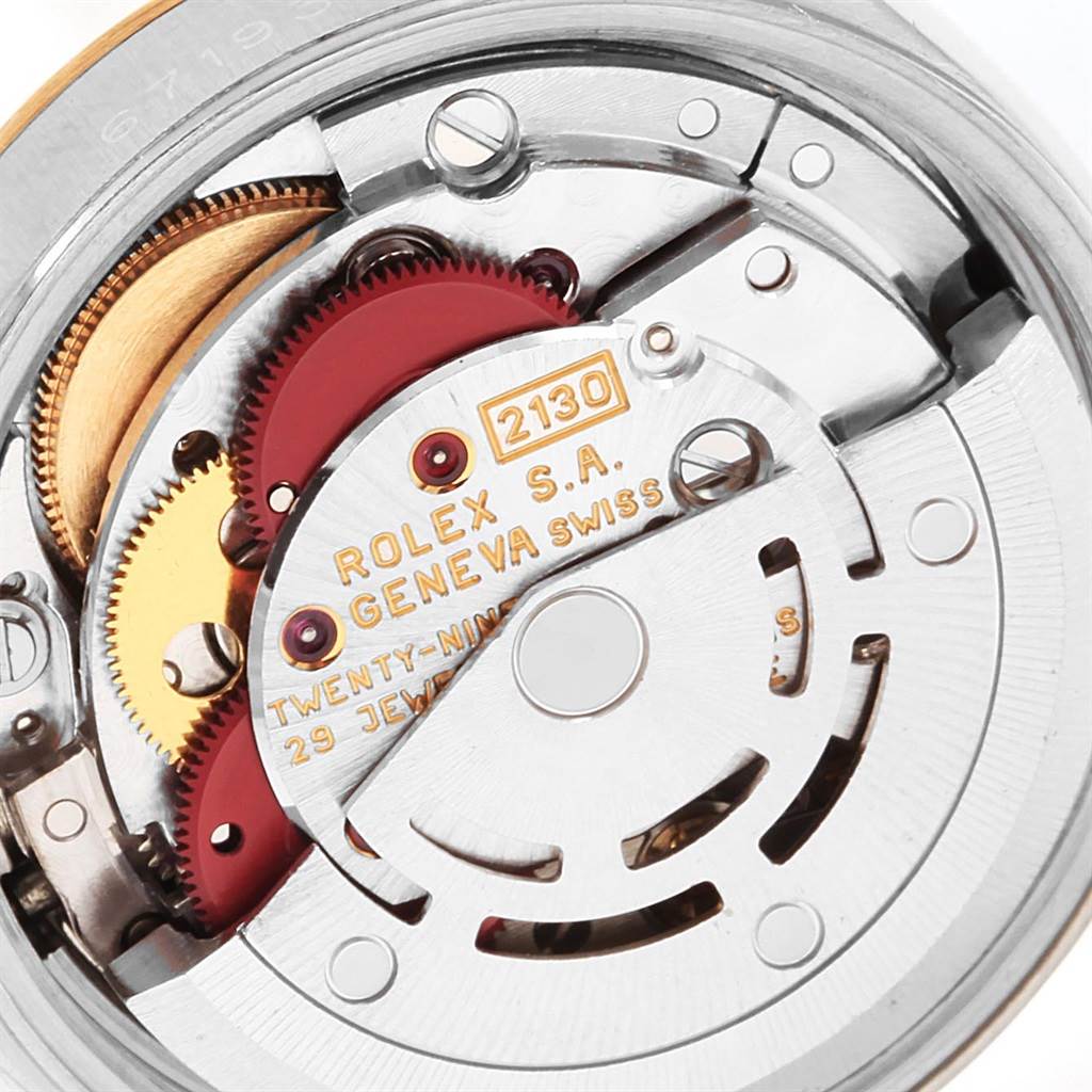 This image shows an internal view of the Rolex Oyster Perpetual 67193 Women
s Steel and Gold (two tone) Silver Dial 67193 Women
s Steel and Gold (two tone) Silver Dial watch mechanism with visible gears and inscriptions.