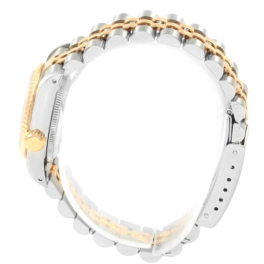 This image shows the side view of the Rolex Oyster Perpetual 67193 Women
s Steel and Gold (two tone) Silver Dial 67193 Women
s Steel and Gold (two tone) Silver Dial watch, highlighting the bracelet, crown, and case from a slightly tilted angle.