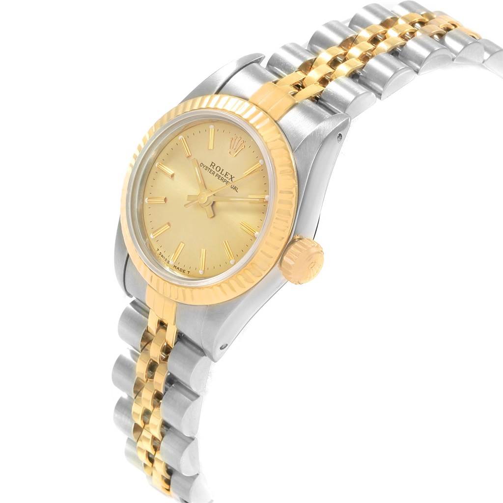 The Rolex Oyster Perpetual 67193 Women's Steel and Gold (two tone) Champagne Dial 67193 Women's Steel and Gold (two tone) Champagne Dial watch is shown from a three-quarter angle, showcasing the gold dial, bezel, crown, and two-tone bracelet.