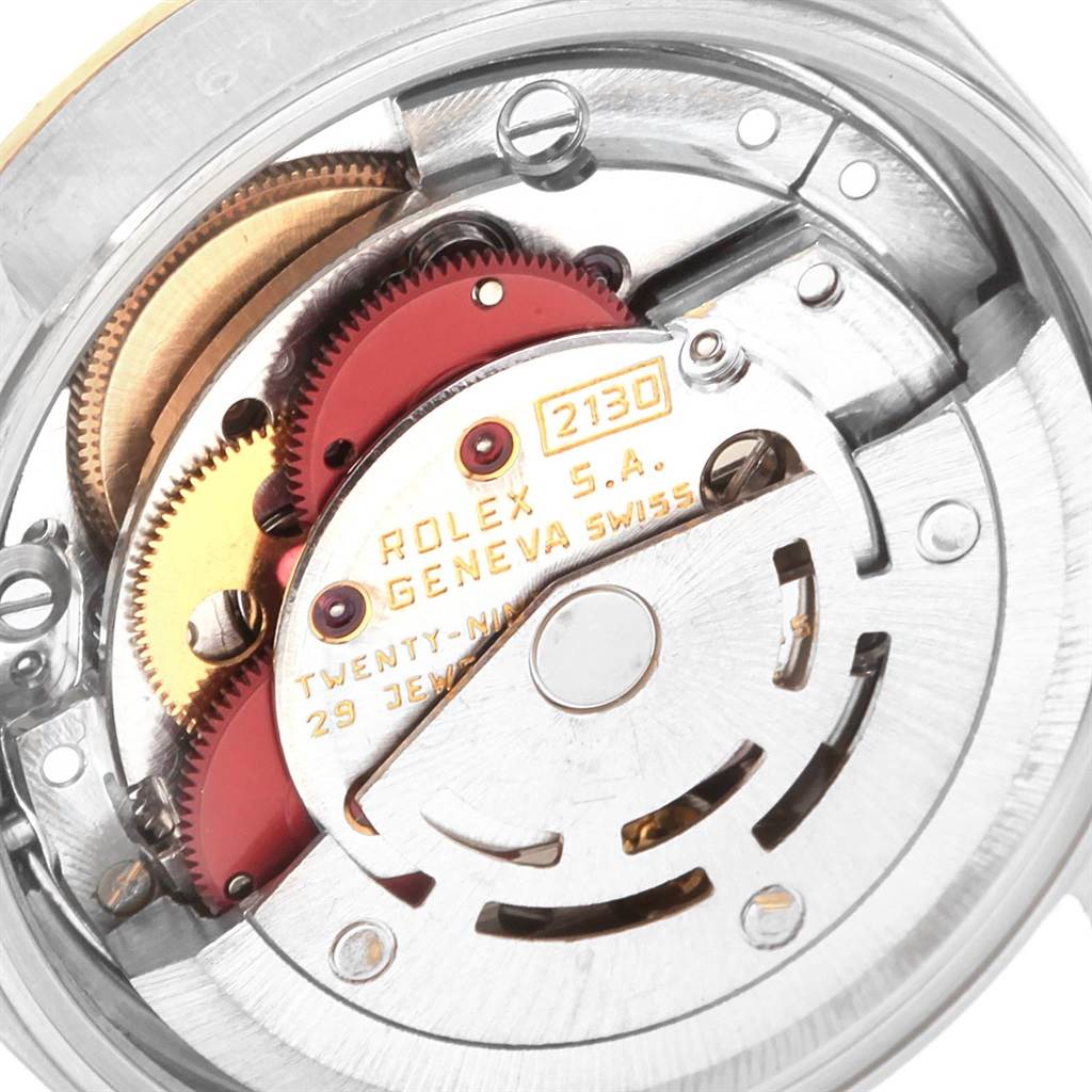 This image shows the intricate internal movement mechanism of a Rolex Oyster Perpetual 67193 Women's Steel and Gold (two tone) Champagne Dial 67193 Women's Steel and Gold (two tone) Champagne Dial watch, highlighting its gears and components.