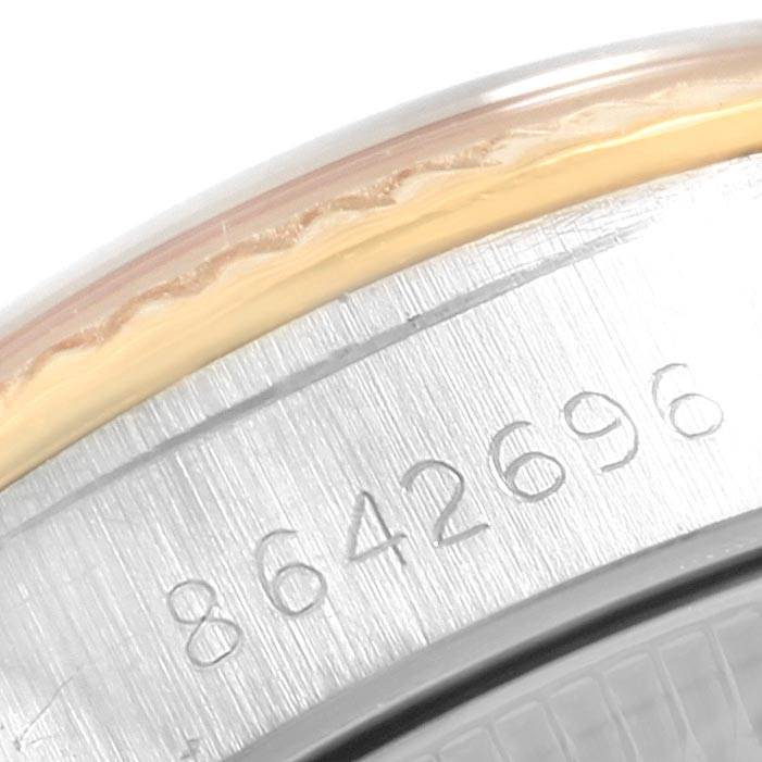 This image shows a close-up of the serial number engraved on the back case of a Rolex Oyster Perpetual 67193 Women's Steel and Gold (two tone) Champagne Dial 67193 Women's Steel and Gold (two tone) Champagne Dial watch.
