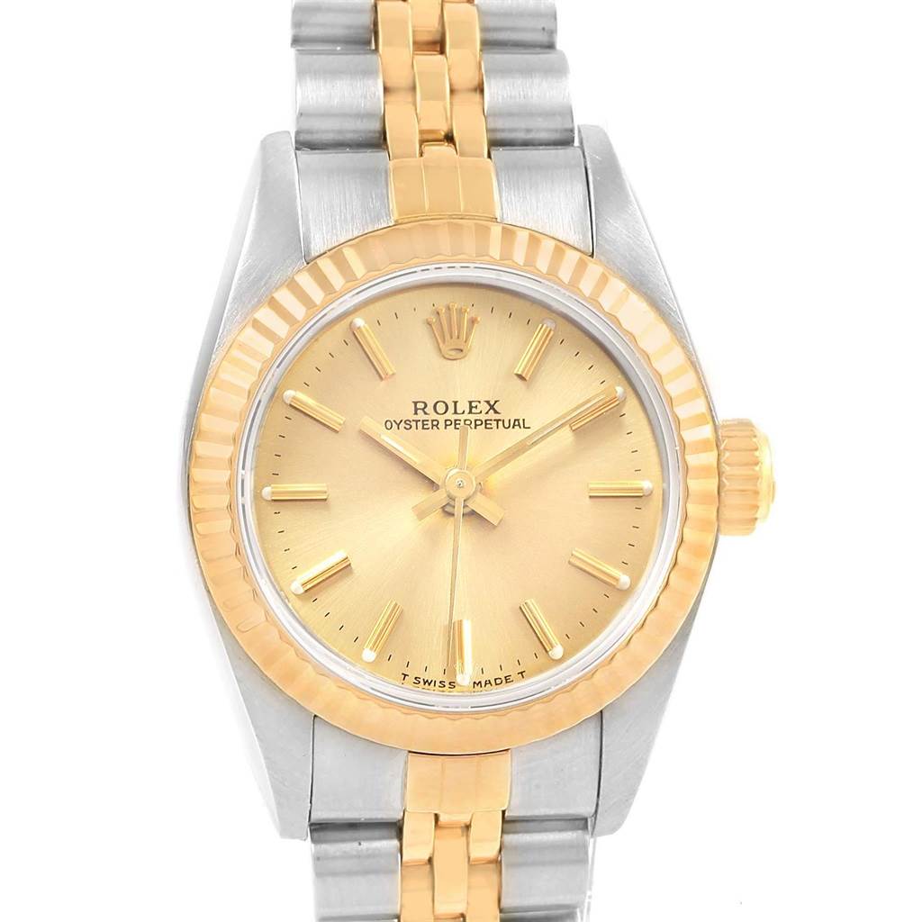 This is a front view of a Rolex Oyster Perpetual 67193 Women's Steel and Gold (two tone) Champagne Dial 67193 Women's Steel and Gold (two tone) Champagne Dial watch showing the face, bezel, crown, and part of the bracelet.