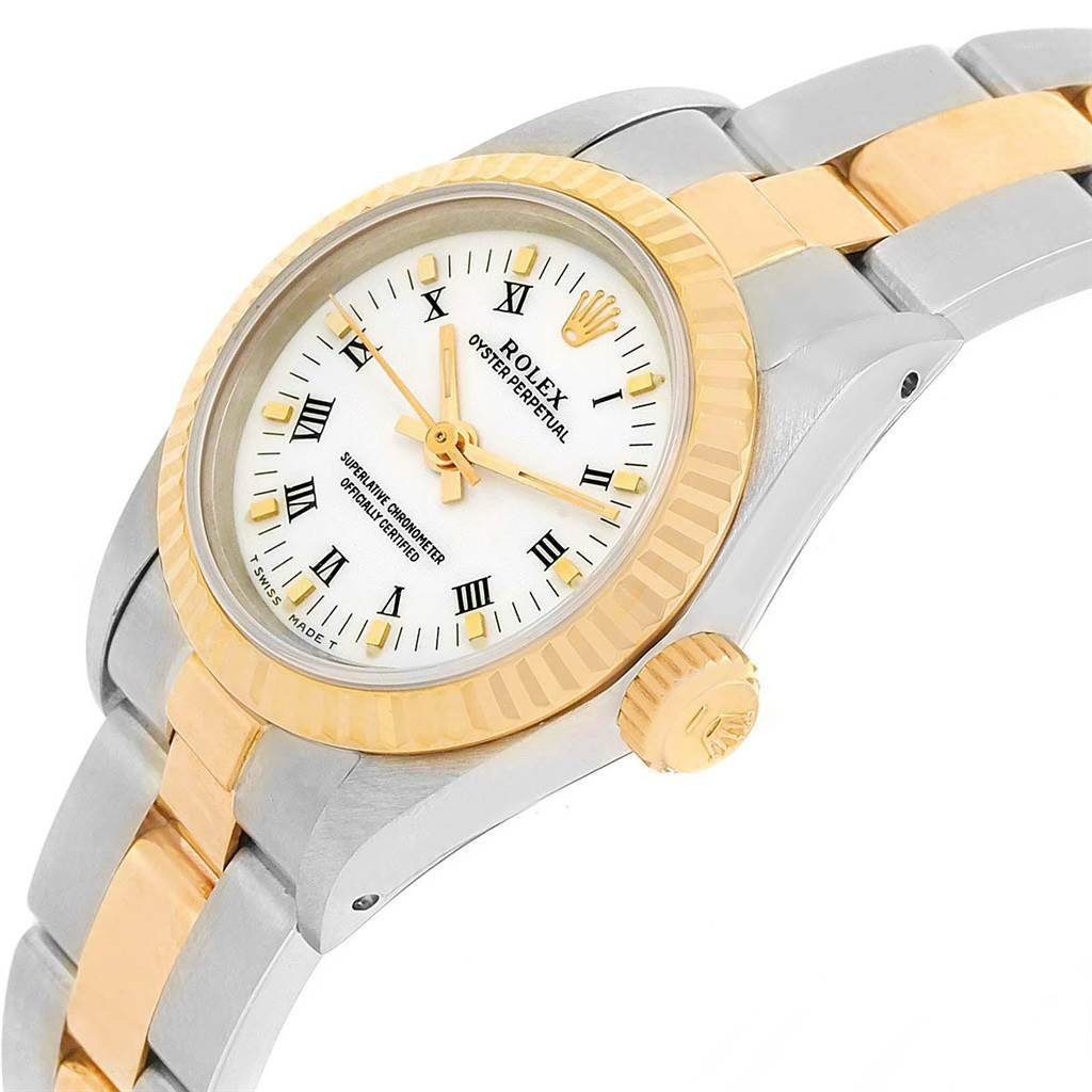 This Rolex Oyster Perpetual 67193 Women's Steel and Gold (two tone) White Dial 67193 Women's Steel and Gold (two tone) White Dial watch is shown from a close-up side angle, highlighting the dial, bezel, crown, and part of the bracelet.
