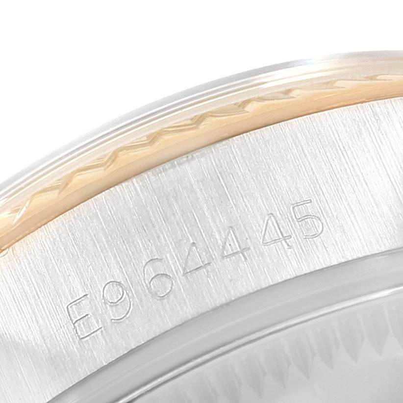 This image shows a close-up of the engraved serial number on a Rolex Oyster Perpetual 67193 Women's Steel and Gold (two tone) White Dial 67193 Women's Steel and Gold (two tone) White Dial watch.