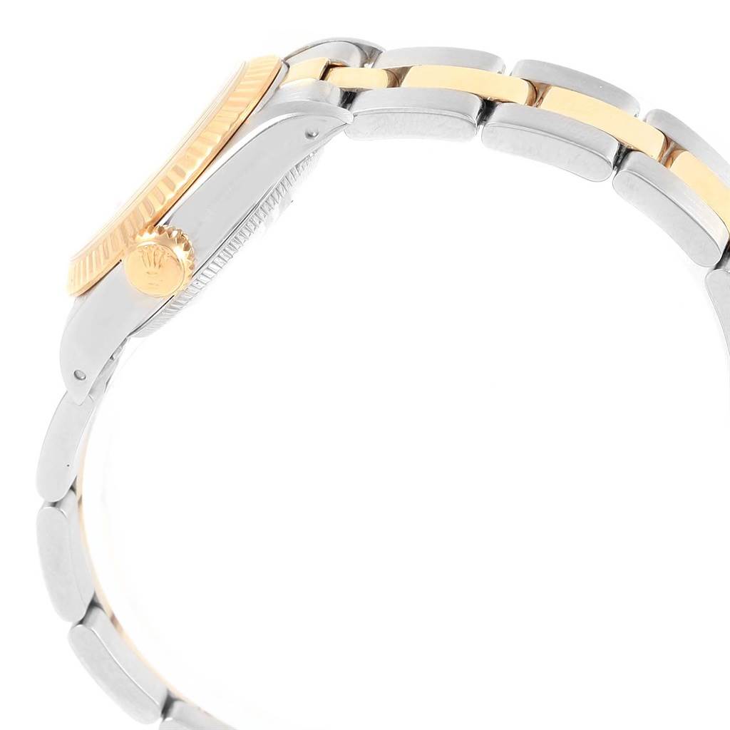 The image shows a side view of the Rolex Oyster Perpetual 67193 Women's Steel and Gold (two tone) White Dial 67193 Women's Steel and Gold (two tone) White Dial watch, highlighting the crown and part of the bracelet.