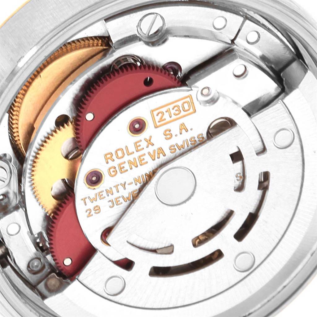 The image shows a close-up view of the internal mechanism of a Rolex Oyster Perpetual 67193 Women's Steel and Gold (two tone) White Dial 67193 Women's Steel and Gold (two tone) White Dial watch, specifically the movement labeled "2130".