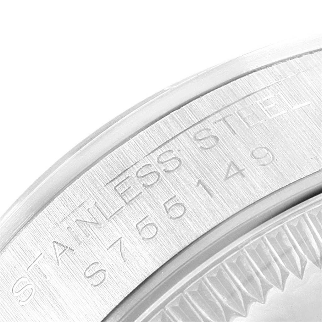 The image shows a close-up of the case and bezel of a Rolex Oyster Perpetual 67180 Women's Stainless Steel White Dial 67180 Women's Stainless Steel White Dial watch, highlighting the "STAINLESS STEEL" engraving.