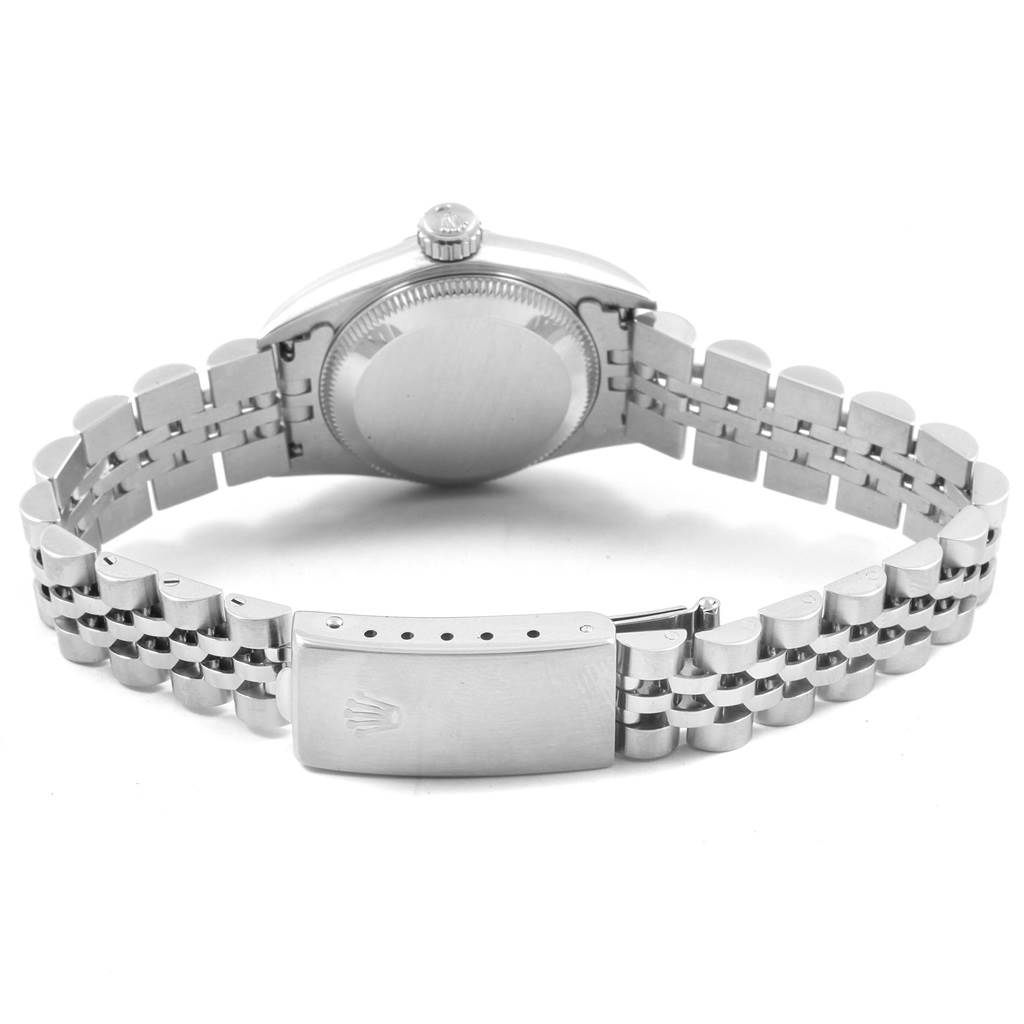 The image shows the backside of the Rolex Oyster Perpetual 67180 Women's Stainless Steel White Dial 67180 Women's Stainless Steel White Dial watch, highlighting the case back and metal bracelet clasp.