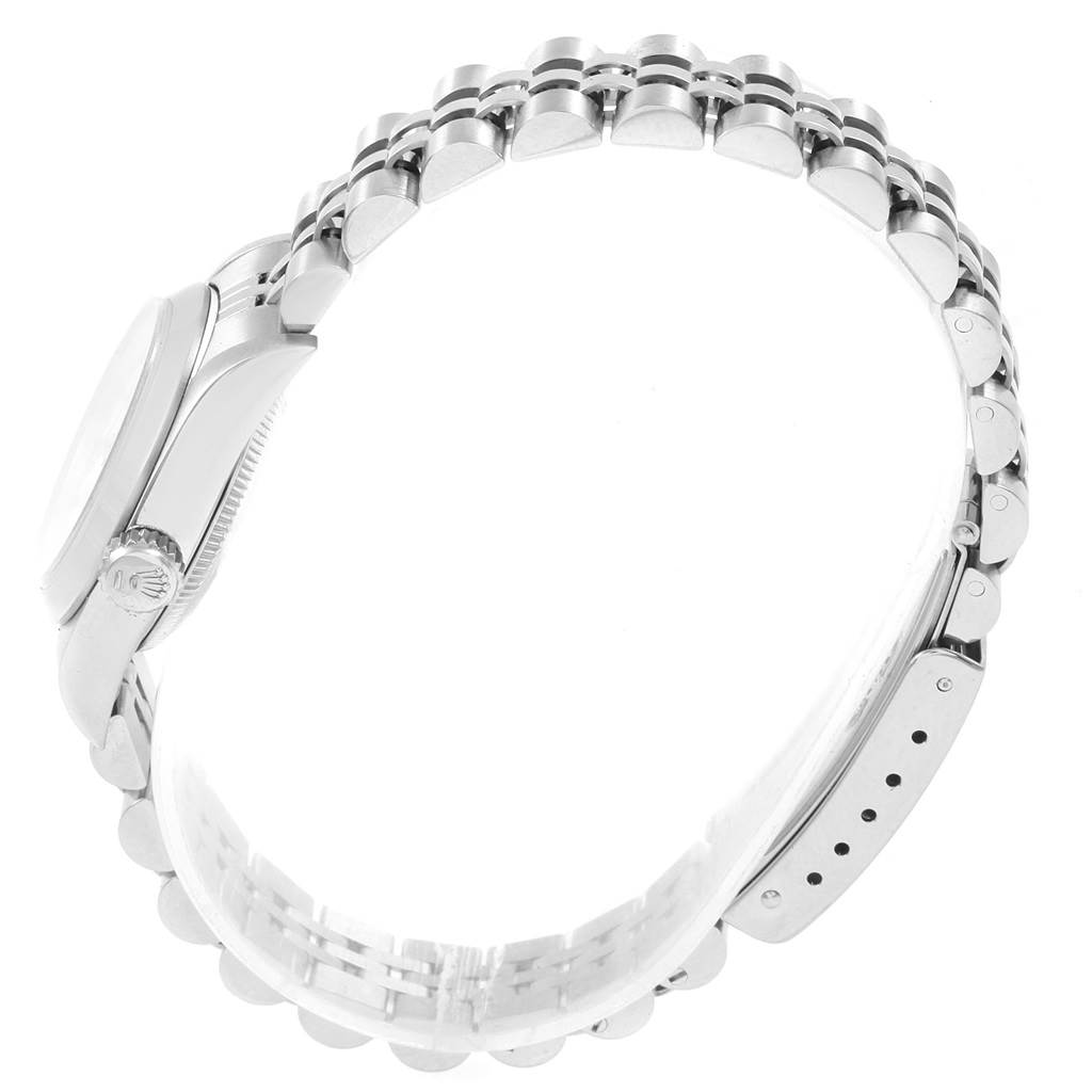 The Rolex Oyster Perpetual 67180 Women's Stainless Steel White Dial 67180 Women's Stainless Steel White Dial watch is shown from a side angle, highlighting its case, crown, and bracelet.