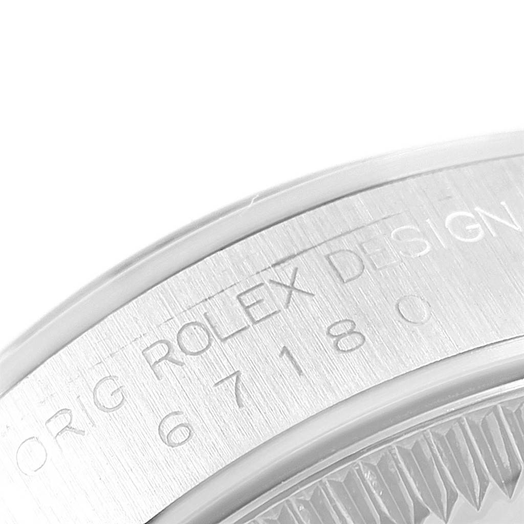 This image shows a close-up angle of the engraved bezel on a Rolex Oyster Perpetual 67180 Women's Stainless Steel White Dial 67180 Women's Stainless Steel White Dial watch.