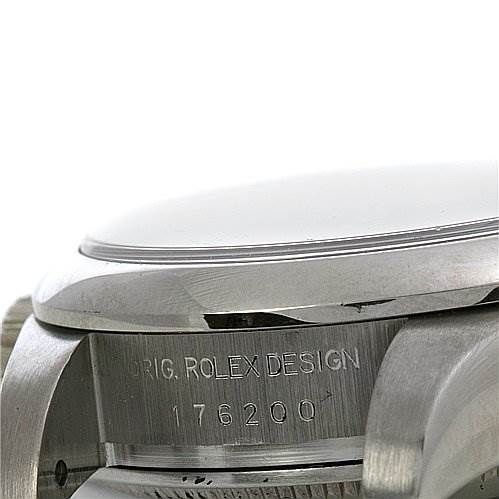 This image shows a close-up of the side of a Rolex Oyster Perpetual 176200 Women's Stainless Steel Black Dial 176200 Women's Stainless Steel Black Dial watch, highlighting the case, bezel, and engraved model number 176200.
