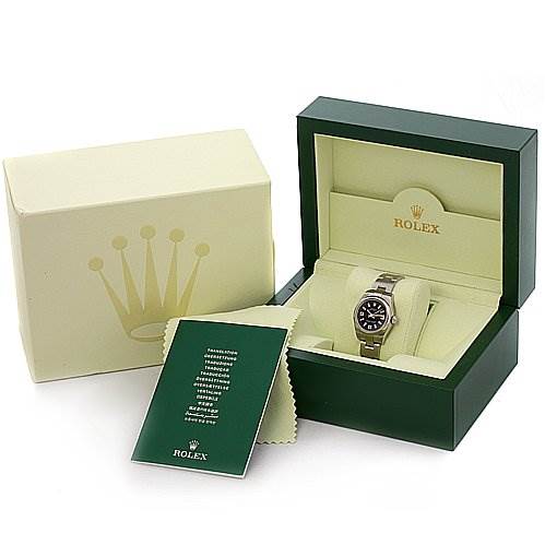 The image shows a Rolex Oyster Perpetual 176200 Women's Stainless Steel Black Dial 176200 Women's Stainless Steel Black Dial watch in its open green and beige box, accompanied by a certificate and a cleaning cloth.