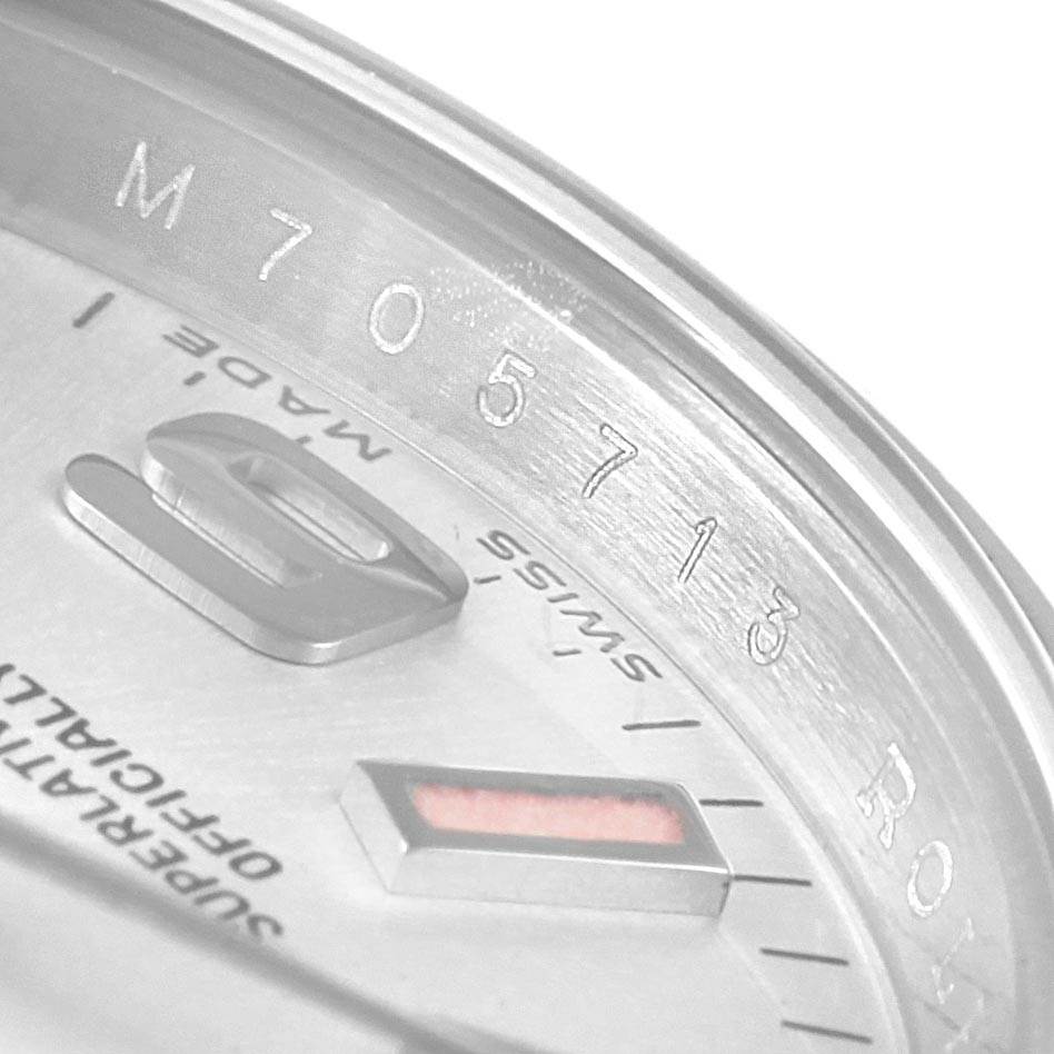 This close-up image shows part of the dial and the engraving on the bezel of the Rolex Oyster Perpetual 176200 Women
s Stainless Steel Silver Dial 176200 Women
s Stainless Steel Silver Dial watch.
