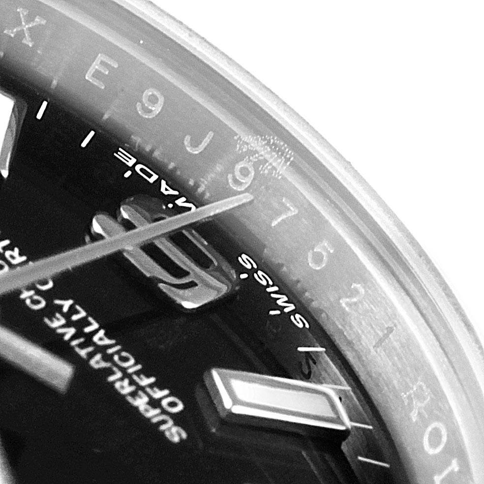 Close-up of the Oyster Perpetual Rolex watch showing its dial, indices, and part of the minute hand.