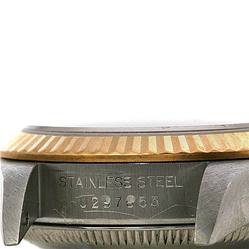 This is a side view of a Rolex Oyster Perpetual 67193 Women's Yellow Gold White Dial 67193 Women's Yellow Gold White Dial watch, showing the stainless steel case and part of the fluted bezel.